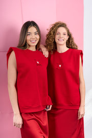 Red sleeveless sweatshirt with detachable prints